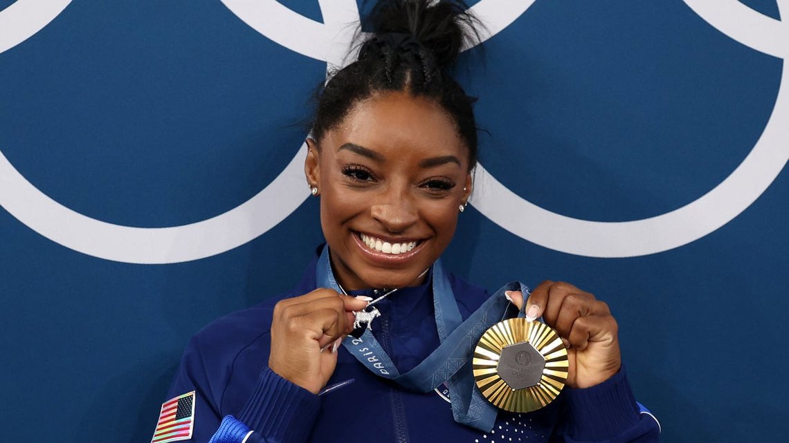 Simone Biles Shows Off New Goat Necklace at Paris Olympics and Loves That ‘Haters Hate It’ [Video]