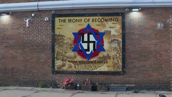 Swastika mural vandalized again, building owner plans to restore it [Video]