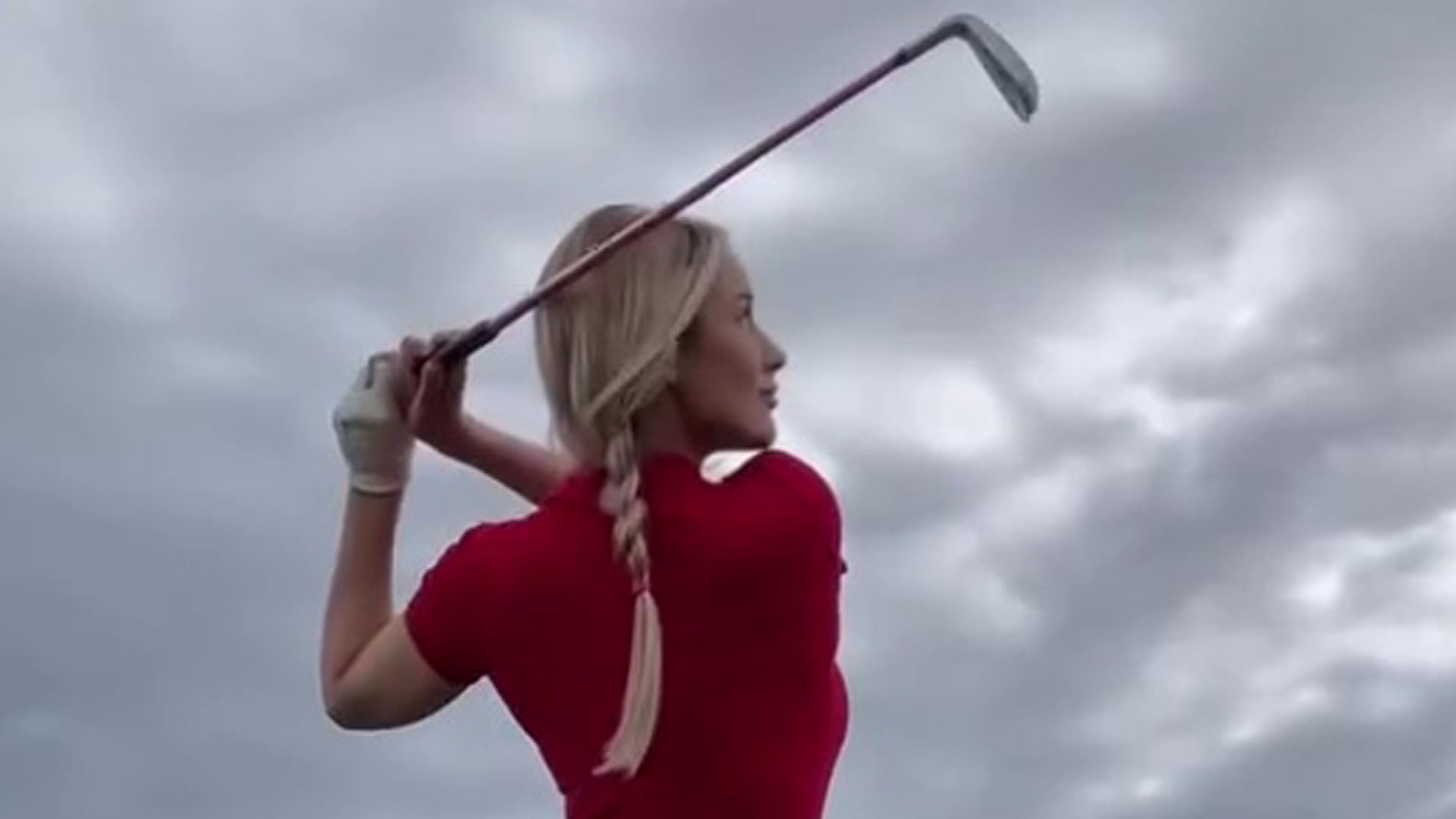 Paige Spiranac goes braless and risks wardrobe malfunction as she shows off golf swing in tight red playsuit [Video]