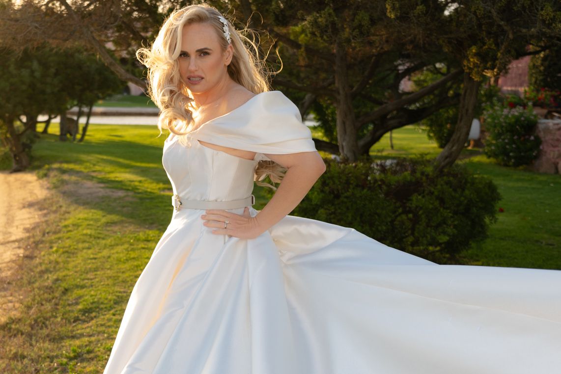 Rebel Wilson and Ramona Agruma Coordinated in Off-the-Shoulder Wedding Dresses: See the Photos [Video]