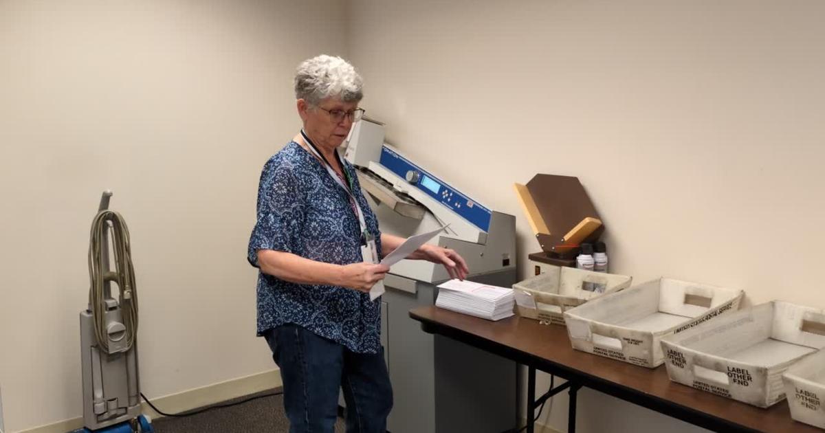 Ballot secrecy envelopes are separated from signed voter affidavits by a machine [Video]