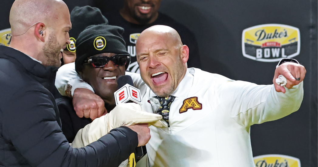 Rapper Flavor Flav helps douse Minnesota coach PJ Fleck at the Duke